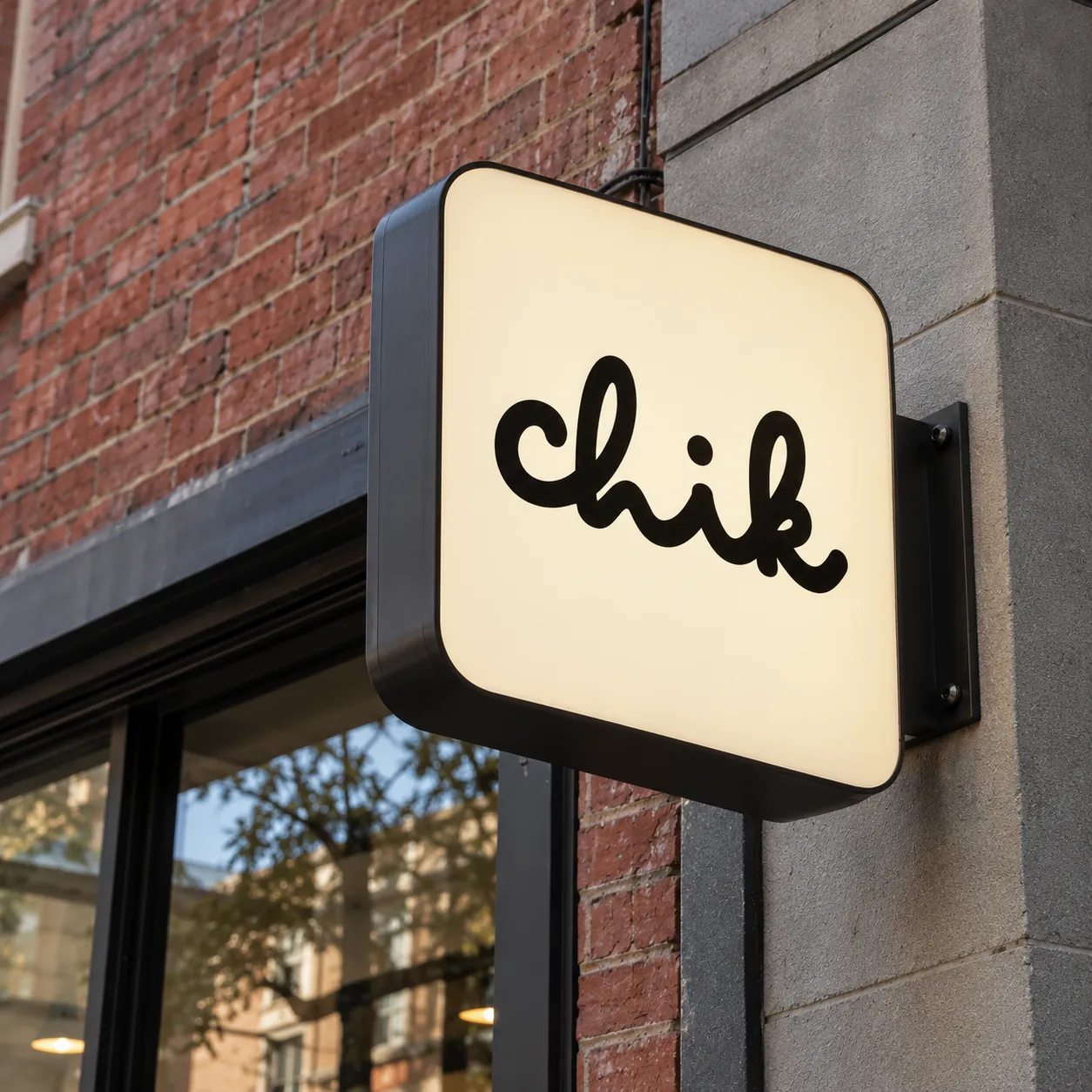 Chik blade sign on a brick wall
